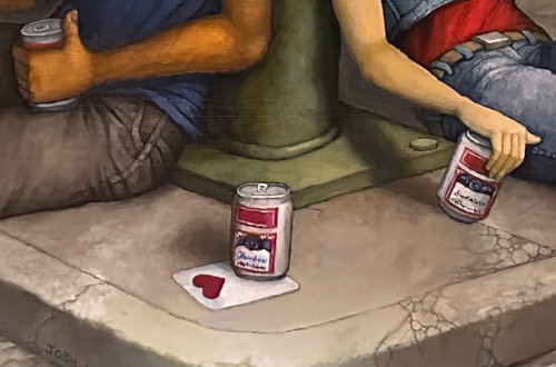 A beer can sits unopned on the sidewalk with a playing card under it, the card has a red heart on it